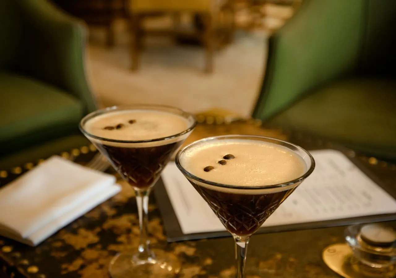 Two espresso martinis on a table in the bar