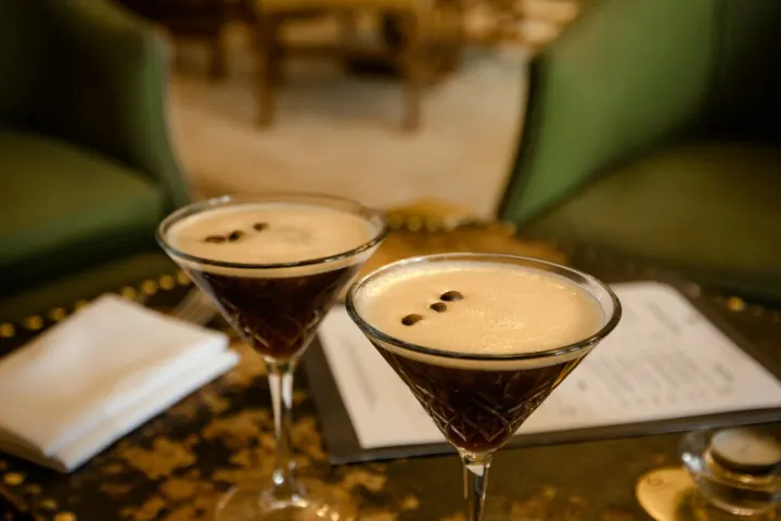 Two espresso martinis on a table in the bar