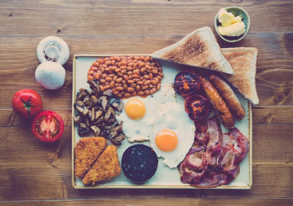 Full cooked breakfast with eggs, sausage, bacon, beans and toast