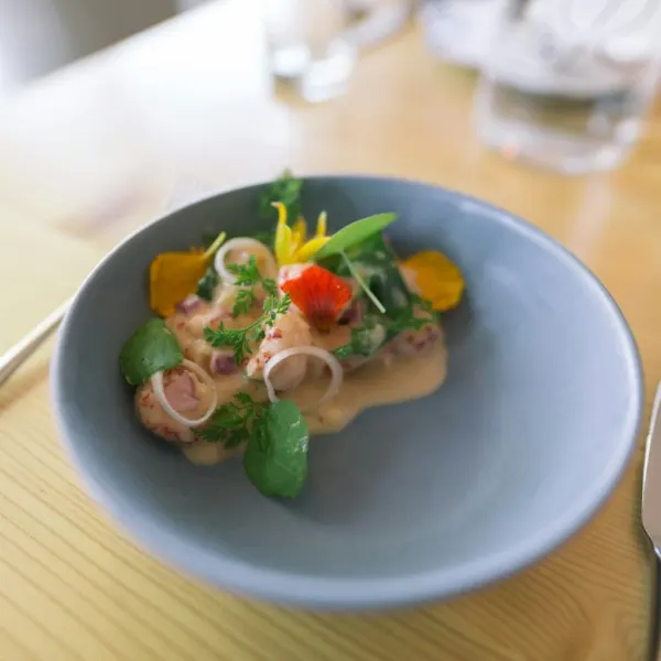 Crab salad with pickled shallots in a pale blue bowl
