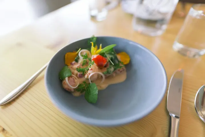 Crab salad with pickled shallots in a pale blue bowl
