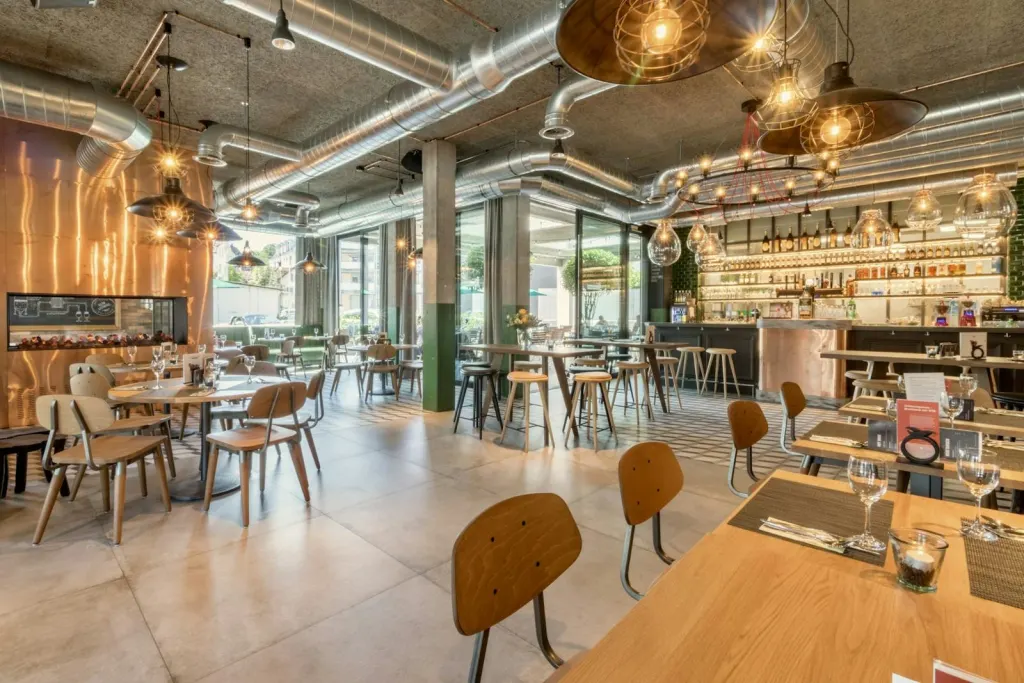 Restaurant dining room with wooden tables and hanging pendant lights