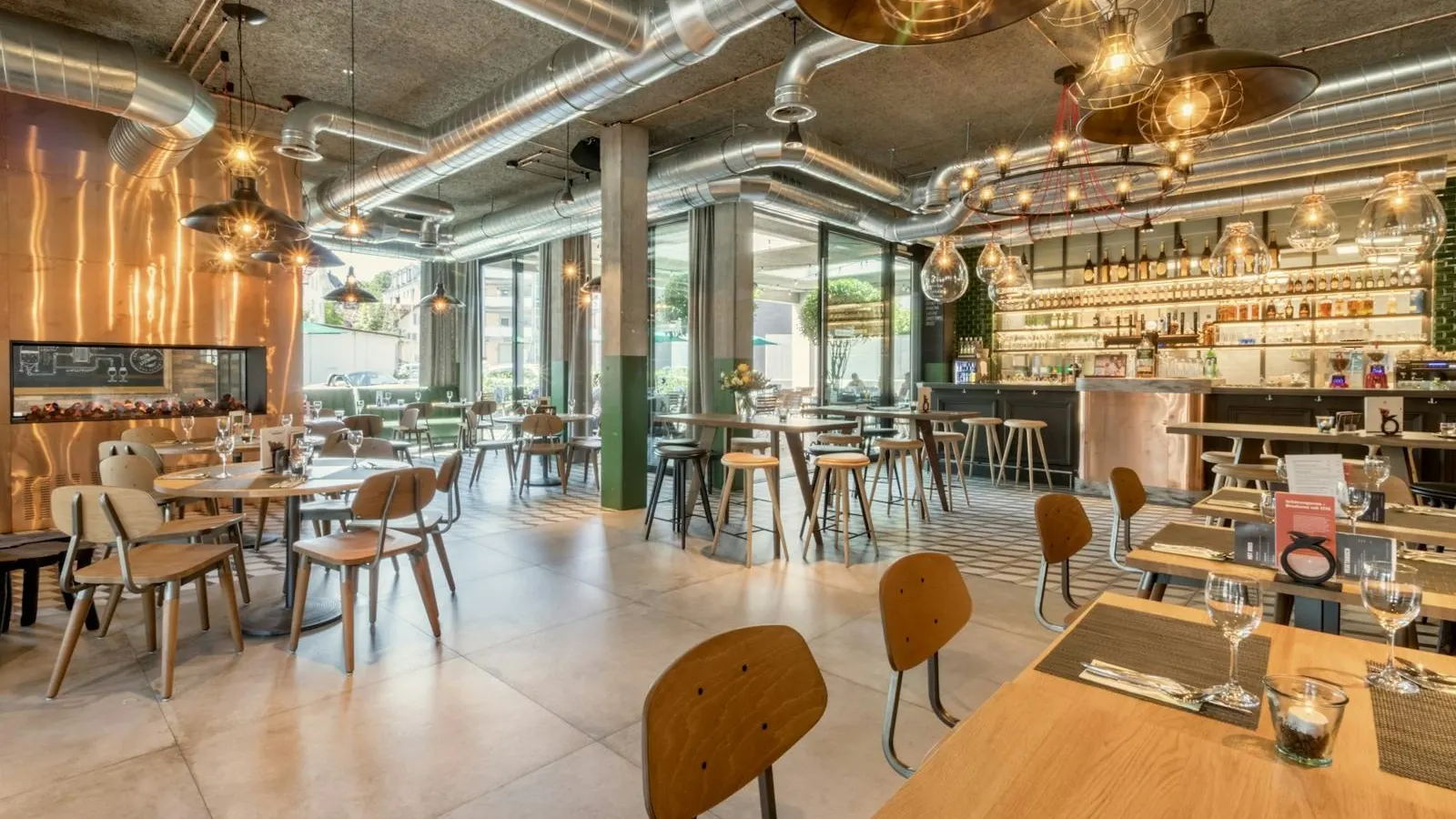 Restaurant dining room with wooden tables and hanging pendant lights