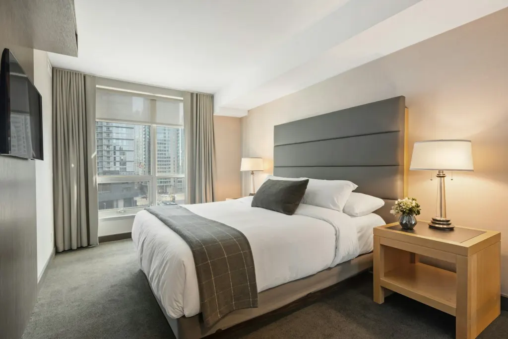 Family room with a king-size bed and a sofa bed beside a window