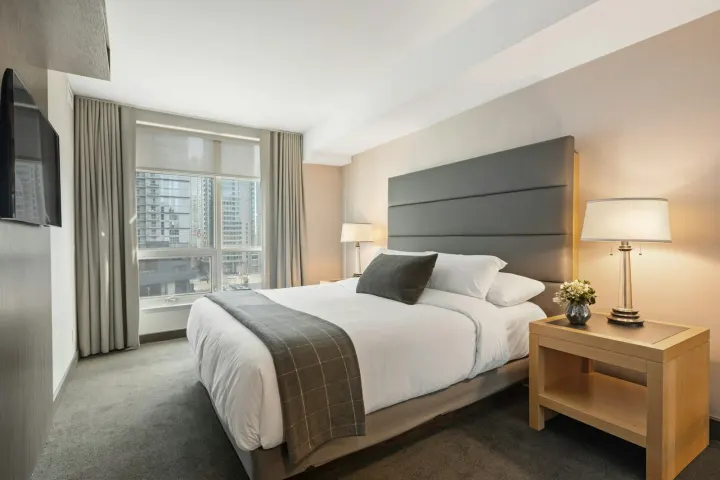 Family room with a king-size bed and a sofa bed beside a window